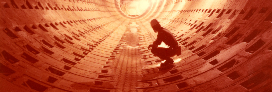 A photograph of a workman in a tunnel